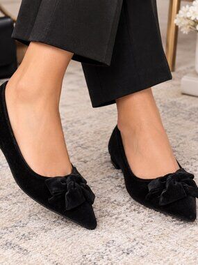Bandolino's Alicce is a pointed-toe flat with a polished bow detail at the toe,